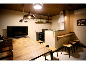 eine Küche mit einem großen Holztisch und einigen Stühlen in der Unterkunft Guest House Garage IMAZU - Vacation STAY 15208 in Takashima
