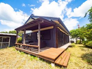 a tiny house with a deck in a yard at At the foot of Nasu, an old private house remodele - Vacation STAY 15220 in Nasushiobara