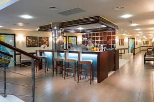 a kitchen with a bar with stools in a restaurant at Mirotel Resort and Spa in Truskavets