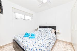 a bedroom with a bed with blue towels on it at VISTA MAR Complejo La Colina in San Agustin +14 photos