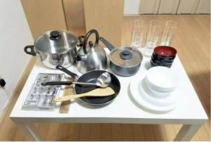 a table with pots and pans and plates on it at SunStay Fudomae 1 - Vacation STAY 35591v in Tokyo