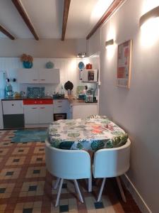 cocina con mesa y mesa pequeña y cocina en Rêve du Revert en Roz-sur-Couesnon