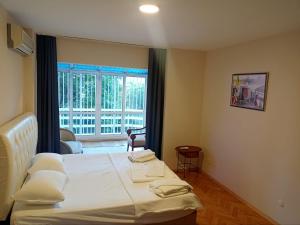 a bedroom with a bed and a large window at Chic Flat w Garden in Bebek, Lux Side of Istanbul in Istanbul