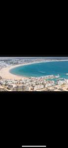 a view of a beach and the ocean from an airplane at Appartement Anir in Agadir