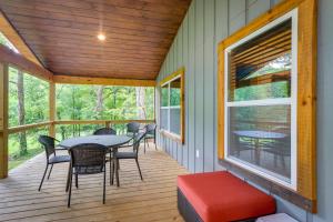a screened porch with a table and chairs on it at Blue Ridge Mountainside Cottage with Fire Pit! in Epworth