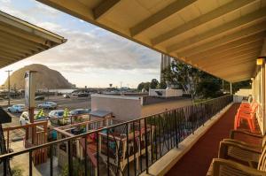 a balcony with chairs and a view of a parking lot at Bayfront Inn in Morro Bay
