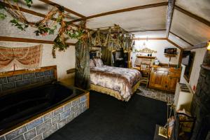 a bedroom with a bed and a bath tub at Castle Wood Theme Cottages- COUPLES ONLY in Big Bear Lake +204 photos