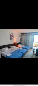 a bedroom with two beds and a window at CORPUS A - Hotel Albatros in Ulcinj