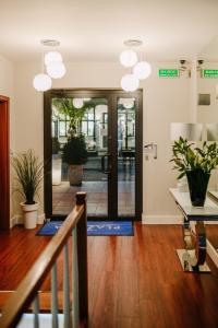 a hallway with a door with potted plants on it at Willa Plażowa in Międzyzdroje