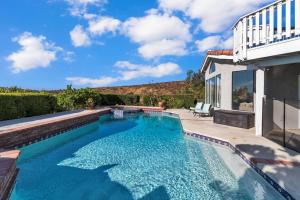 a swimming pool next to a house at Oaks Garden in Thousand Oaks