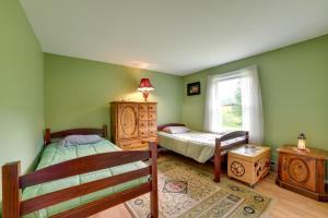 a bedroom with two beds and a window at Quiet Catskills Getaway with Deck-Panoramic Mtn Views in New Kingston