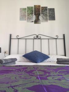 a bed with a black frame and a blue pillow at Mirador de los Amantes - VUTE-23-019 in Teruel