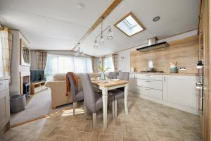 a kitchen and dining room with a table and chairs at Stones Throw Lodge in Padstow