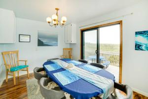 a bedroom with a table and chairs and a balcony at Rahus Ocean Refuge with Manchester Coast Views! in Manchester