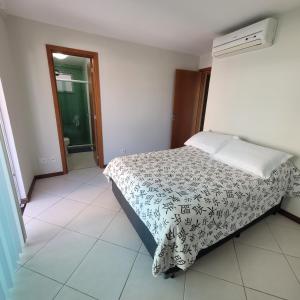 a small bedroom with a bed and a window at Apartamento em Cabo Frio - Braga - RJ in Cabo Frio +46 photos