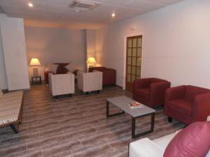 a living room with couches and chairs and a table at Hotel Marblau Tossa in Tossa de Mar