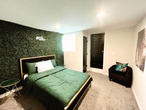 a bedroom with a green bed and a chair at 1 Bed 1 Bath Basement Apartment with Private Entrance in Baltimore