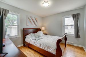 a bedroom with a bed and two windows at Pet-Friendly Southfield House with Ping Pong Table! in Southfield