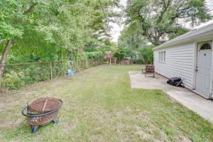 a backyard with a grill and a fence and a house at Pet-Friendly Southfield House with Ping Pong Table! in Southfield