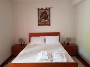 a bedroom with a bed with two towels on it at Casa da Piedade, Vouzela in Vouzela