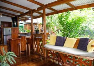 a living room with a wooden pergola at Colibri Ecolodge 3 minutes walk to beach and town in Puerto Viejo