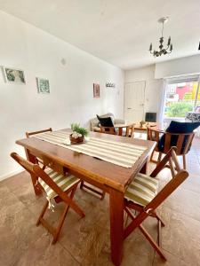 a dining room with a wooden table and chairs at Pepa in Tandil