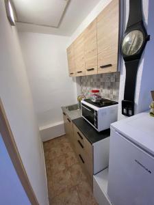 a small kitchen with a microwave on a counter at Apartmani Lipa in Višegrad