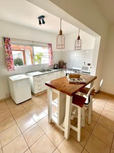 a kitchen with a wooden table and a sink at Pepa in Tandil