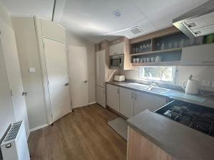 a small kitchen with a sink and a stove at 28 Roman’s Parade in Belton