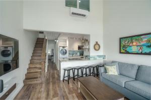 a living room with a couch and a kitchen at 401 Maalaea Banyans in Wailuku