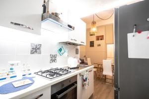 kuchnia z kuchenką i lodówką w obiekcie casa vacanze Casa del Mare w mieście Aci Trezza