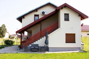 a white house with a red railing at Timeless in Gospić