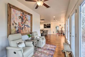 a living room with two chairs and a painting on the wall at Fulshear Villa with Guest House and Scenic Views! in Brookshire