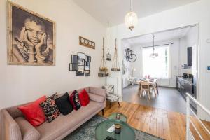 a living room with a couch and a table at Superb 3 Bedroom & 3 Bathroom Duplex In Brussels City Centre in Brussels
