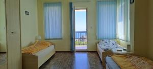 a room with two beds and a window with a view at Villa Byala Grape House in Byala +57 photos