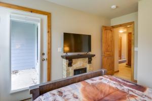 a bedroom with a fireplace and a flat screen tv at Crested Butte Getaway Near Skiing and Shopping! in Crested Butte