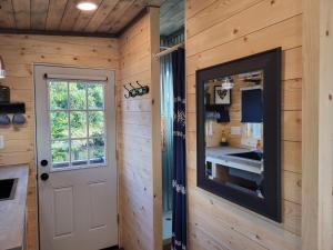 a door to a kitchen in a log cabin at Tiny Home By The Beach in Blaine