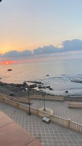 a view of the ocean at sunset from a building at Primera línea de playa en Villaricos in Villaricos