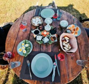a wooden table with plates of food on it at BioFarm Gramsh 