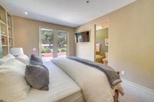 a bedroom with a large bed with white pillows at Chic California Escape with Pool, Hot Tub and Patio! in Salinas
