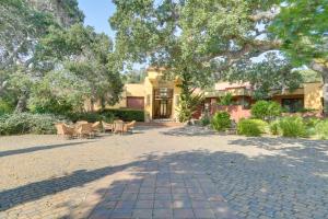 a house with a tree and chairs and a sidewalk at Chic California Escape with Pool, Hot Tub and Patio! in Salinas