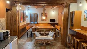 a room with a table and a couch and a kitchen at Casa Rural La Plaza in Valoria la Buena