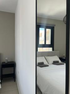 een slaapkamer met een groot wit bed en een raam bij Sea La Vie #1 - Luxury Seaview apartment in Paphos City