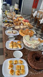 a buffet with many plates of food on a table at Águas Palace Hotel in Petrolina