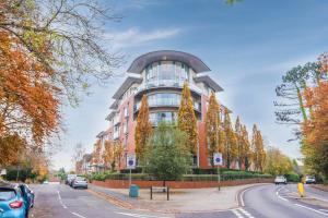 a large building with trees in front of it at Executive Corporate Penthouse in Woking