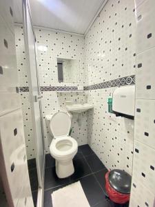 a small bathroom with a toilet and a sink at Hotel Bogotá Chapinero in Bogotá