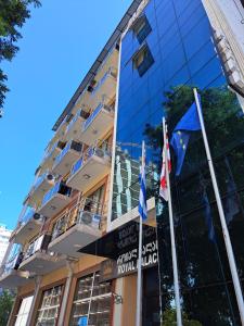 a building with flags in front of it at Hotel Royal Palace in Batumi