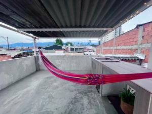 a hammock on top of a roof at Hostal Casa Amatista in Pereira