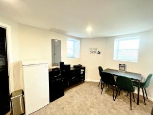 a kitchen with a table and chairs and a desk at 1 Bed 1 Bath Basement Apartment with Private Entrance in Baltimore