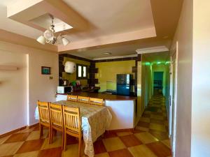 a kitchen and dining room with a table and chairs at Clara Apartment in Alexandria